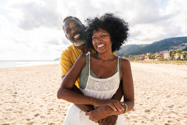 Beautiful mature black couple of lovers dating at the seaside - Married african middle-aged couple bonding and having fun outdoors, concepts about relationship, lifestyle and quality of life - DMDF10422