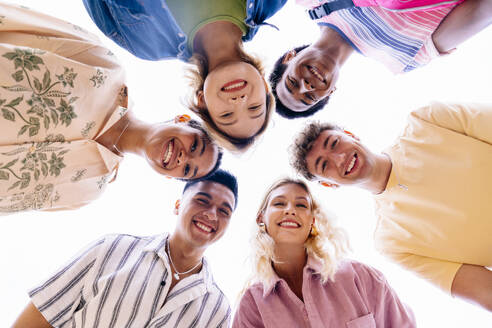 Multiethnic group of young friends with colorful clothing bonding outdoors in the city, concepts about youth and lifestyle - Barcelona, Spain - OIPF03996