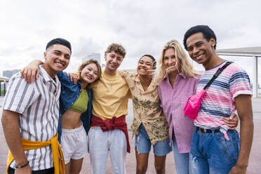 Gruppenfoto von glücklichen jungen Freunden mit bunter Kleidung, die in die Kamera lächeln - OIPF04038
