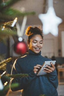 Young woman using tablet PC at home - JOSEF23814