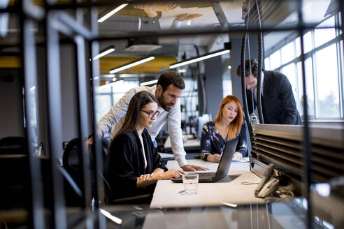 Group of young business people are working together on a laptop - INGF13071