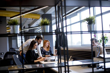 Group of young business people are working together on a laptop - INGF13072