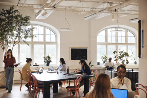 Multiracial team of male and female business professionals working at coworking office - MASF43047