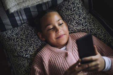 Little girl in underwear lying on bed looking at smartphone, Stock Photo,  Picture And Royalty Free Image. Pic. WES-VABF02724