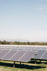 Solar panels mounted in rows against sky in field - MASF43267