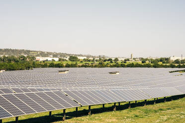Solar panels in rows against sky at power station - MASF43269