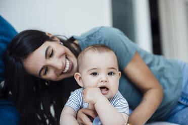 Smiling mother with cute baby girl at home - JOSEF23859