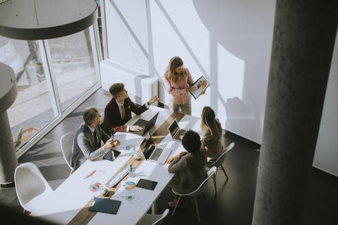 Overhead view at group of multiethnic business people working together in the office - INGF13161