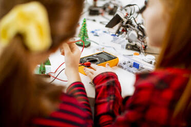 Group of happy kids programming electric toys and robots at robotics classroom - INGF13210