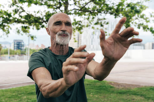 Active senior man exercising at park - OIPF04103