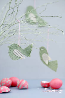 Cracked Easter eggs and twigs decorated with paper birds - GISF01041