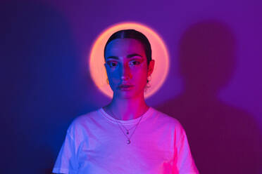 Woman in neon lighting against gradient background - EGHF00875