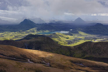 Aerial view of people on the mountain ridge overlooking the volcanic landscape with volcanic lakes, Highlands, iceland. - AAEF26052