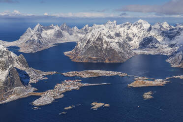 Aerial view of small fishing villages along the fjords coastline in winter, Lofoten Islands, Norway. - AAEF26114