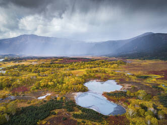 Aerial view of Uzon, a volcanic caldera and geothermal area with hot spring water in Kamchatka Krai peninsula, Russia. - AAEF26151