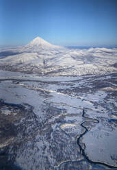 Aerial view of mountain landscape with river crossing the valley in winter with snow in the Kamchatka Krai region, Russia. - AAEF26186