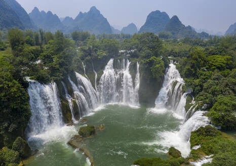 Aerial view of Detian Transnational Waterfalls along the river at Moon Hill Yangshuo valley, Chongzuo City, Yangshuo County, Guilin, Guangxi Zhuang Autonomous Region, China. - AAEF26220