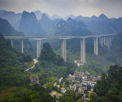 Aerial view of a suspended highway bridge crossing the Moon Hill Yangshuo, a scenic hilly landscape, Yangshuo County, Guilin, Guangxi Zhuang Autonomous Region, China. - AAEF26226