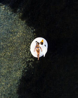 Aerial view of a woman relaxing in the sea, Primorje-Gorski Kotar, Croatia. - AAEF26249