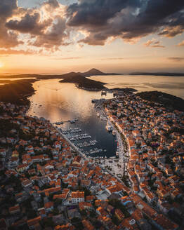 Aerial view of coastal town with orange sunset and marina, Mali Losinj, Primorje-Gorski Kotar, Croatia. - AAEF26255