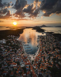 Aerial view of coastal town with orange sunset and marina, Mali Losinj, Primorje-Gorski Kotar, Croatia. - AAEF26256