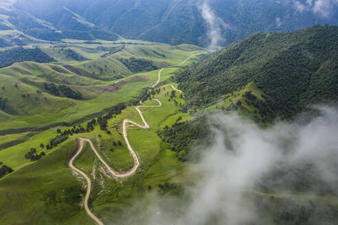 Aerial view of beautiful mountain landscape with road crossing the valley in Karachay-Cherkess, Elbrus, Khabaz, Kebardino Balkaria, Caucasus, Russia. - AAEF26276