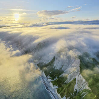 Aerial view of Iturup Island along Sea of Okhotsk coastline, Kuril Archipelago, Sakhalin Oblast, Russia. - AAEF26280