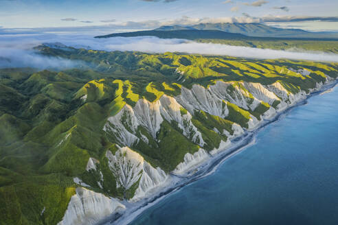 Aerial view of Iturup Island along Sea of Okhotsk coastline, Kuril Archipelago, Sakhalin Oblast, Russia. - AAEF26281