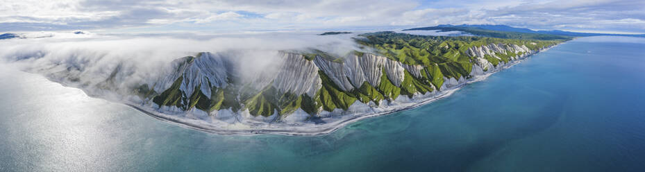 Aerial panoramic view of Iturup Island along Sea of Okhotsk coastline, Kuril Archipelago, Sakhalin Oblast, Russia. - AAEF26287