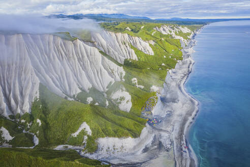 Aerial panoramic view of Iturup Island along Sea of Okhotsk coastline, Kuril Archipelago, Sakhalin Oblast, Russia. - AAEF26290