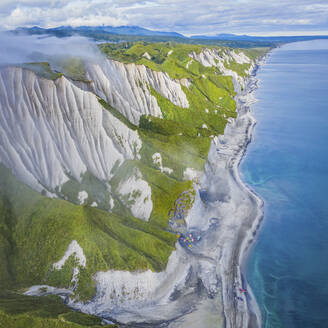 Aerial panoramic view of Iturup Island along Sea of Okhotsk coastline, Kuril Archipelago, Sakhalin Oblast, Russia. - AAEF26291