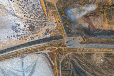 Aerial view of a road crossing the Elton Lake coastline, a large salt lake with minerals in Vengelovskoe, Volgograd Oblast, Russia. - AAEF26383