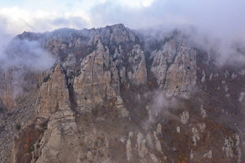 Aerial view of a mountain landscape with low clouds and fog at sunset in Crimea Region, Autonomous Republic of Crimea, Ukraine. - AAEF26416