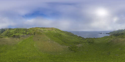 Aerial panoramic view of the coastline on Ostrov Moneron island, Nevelsk, Sakhalin Oblast, Russia. - AAEF26431