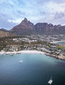 Aerial view of yachts moored in a bay with white sandy beaches and boulders and mountains in the background, and houses in the landscape Cape Town, Western Cape, South Africa. - AAEF26511