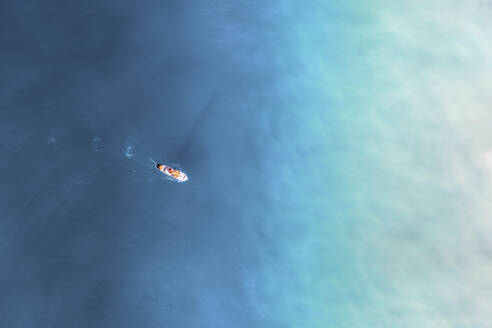 Aerial view of an orange paddle board in the crystal clear ocean water, Cape Town, Western Cape, South Africa. - AAEF26515