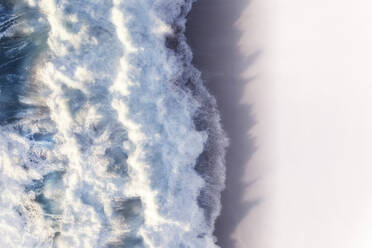 Aerial view of large waves crashing onto a pristine white sandy beach shore, Cape Town, Western Cape, South Africa. - AAEF26567