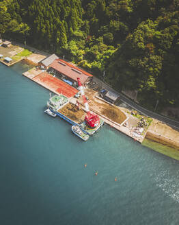 Aerial shot of a crane on a boat, Ine Bay, Ine, Kyoto Prefecture, Japan. - AAEF26735