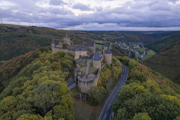 Aerial drone view of Bourscheid castle on forest hill top with panoramic view in Luxembourg. - AAEF26769