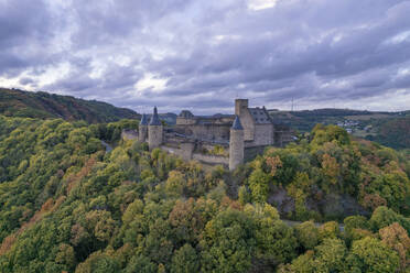 Aerial drone view of Bourscheid castle on forest hill top with panoramic view in Luxembourg. - AAEF26773