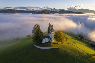 Aerial drone view of the beautiful hilltop church of Sveti Tomaz (Saint Thomas) Skofja loka, Slovenia. - AAEF26809
