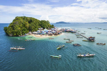 Aerial Drone View of Island Village with Canoes in the Sea Near to Jayapura City, Indonesia. - AAEF26940