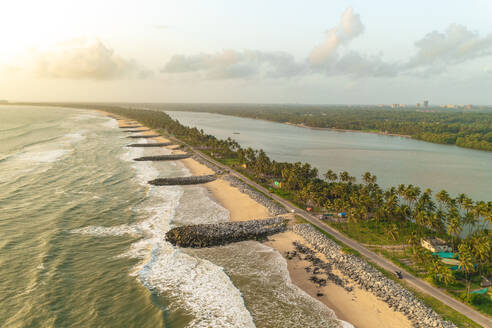 Aerial view of breakwater along a strip of land with Pithrody beach and long coastline along the Arabian Sea, Udupi, Karnataka, India. - AAEF26982