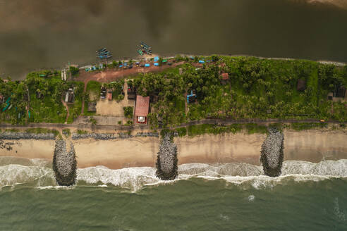 Aerial view of breakwater along a strip of land with Pithrody beach and long coastline along the Arabian Sea, Udupi, Karnataka, India. - AAEF26984