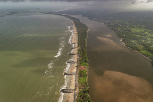 Aerial view of breakwater along a strip of land with Pithrody beach and long coastline along the Arabian Sea, Udupi, Karnataka, India. - AAEF26985