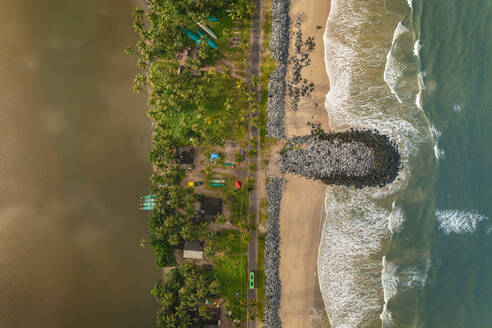 Aerial view of breakwater along a strip of land with Pithrody beach and long coastline along the Arabian Sea, Udupi, Karnataka, India. - AAEF26987