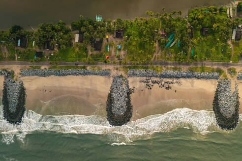 Aerial view of breakwater along a strip of land with Pithrody beach and long coastline along the Arabian Sea, Udupi, Karnataka, India. - AAEF26988