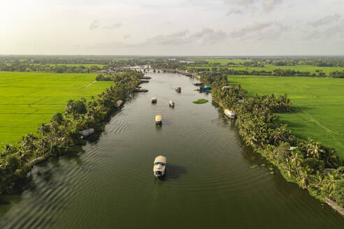 Aerial view of boats sailing the river water in Alappuzha, Kerala, India. - AAEF27008