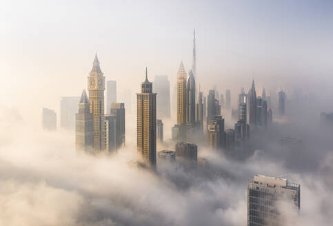 Aerial view of Burj Khalifa and Downtown Dubai surrounded by hazy clouds, Dubai, United Arab Emirates. - AAEF27026
