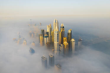 Aerial view of Dubai Marina at sunrise with fog and skyscrapers, Dubai, United Arab Emirates. - AAEF27029